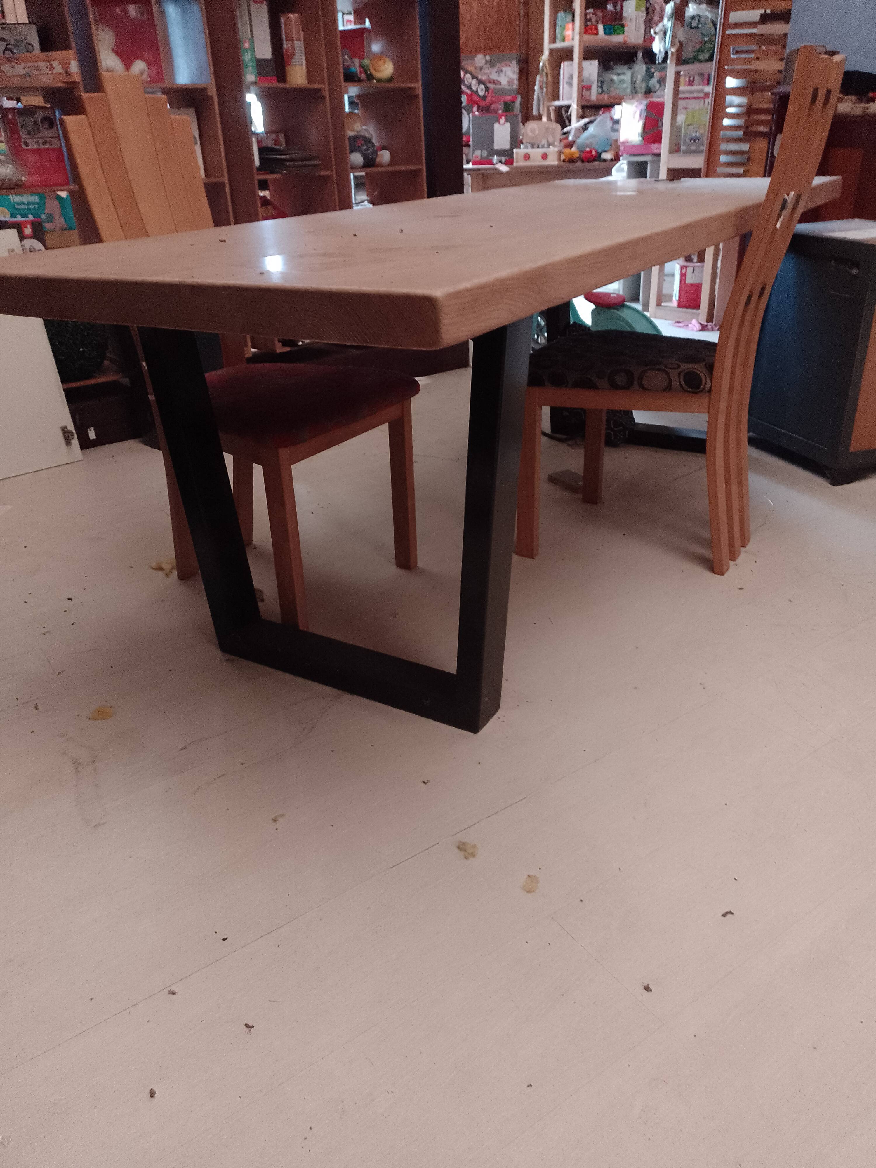 Modern table with metal legs and a natural varnished solid oak top