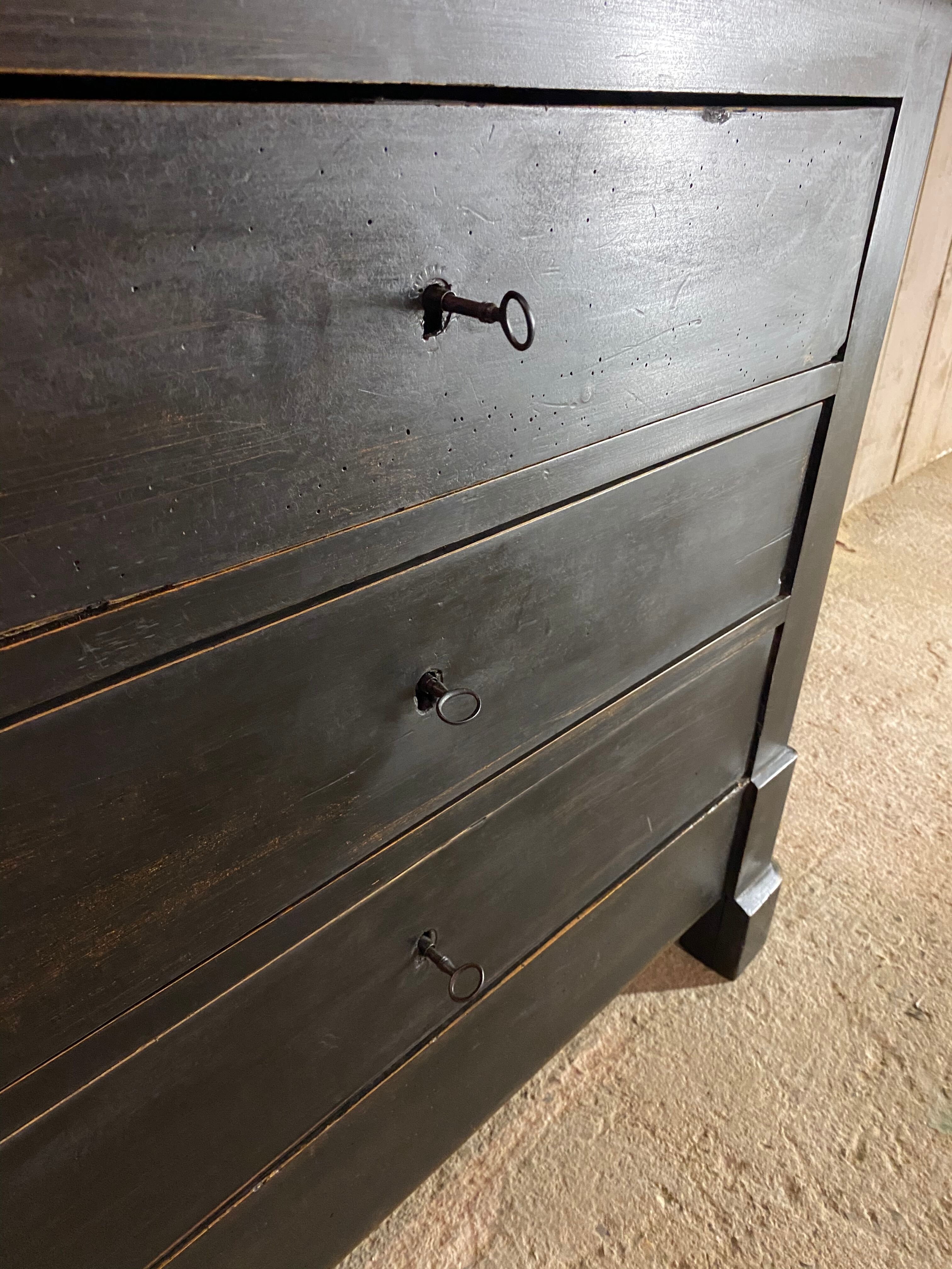 Old black patinated chest of drawers