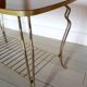 Table basse vintage en bois laqué et métal doré
