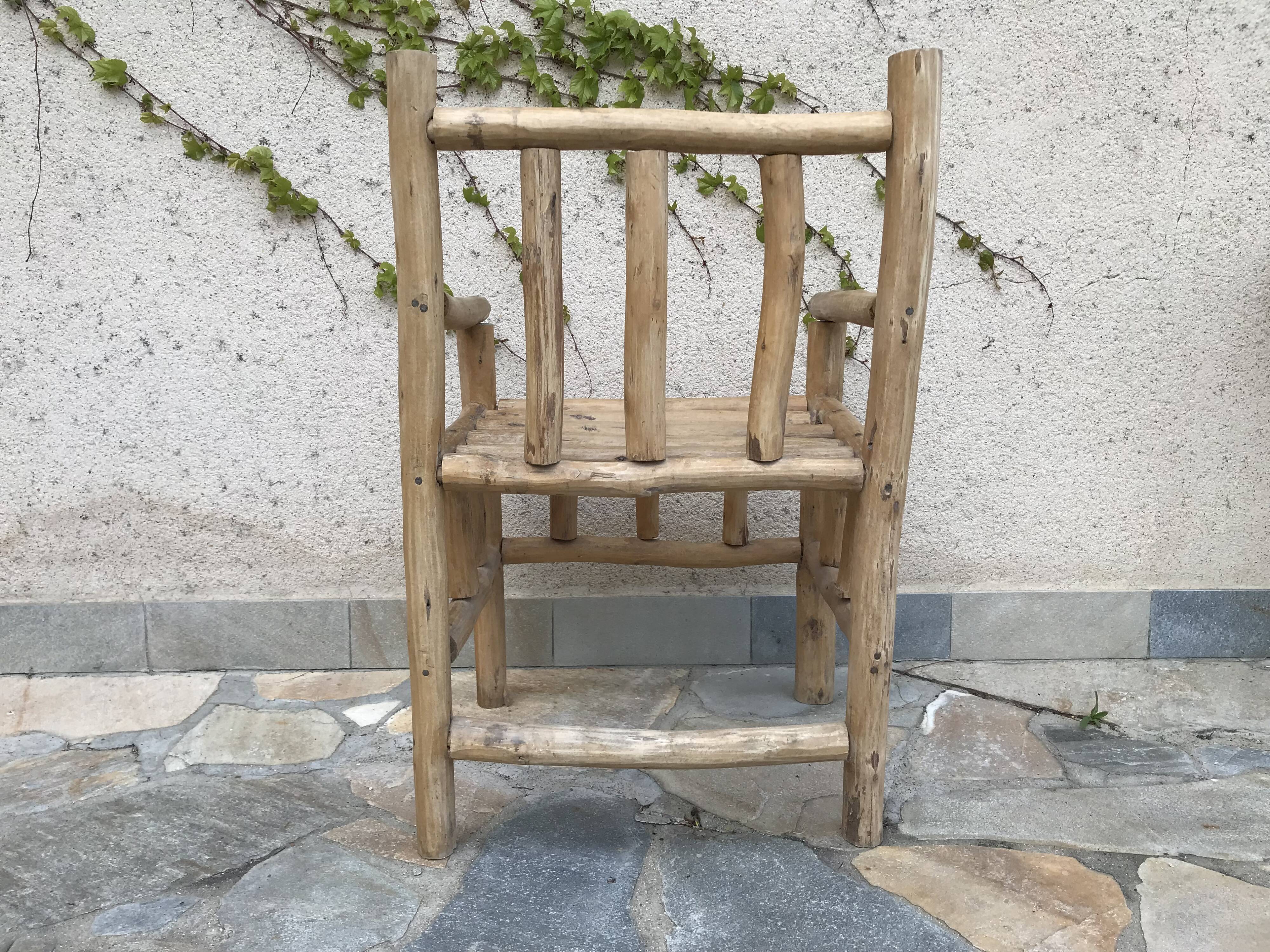 Art-Populaire armchair in raw wood, circa 1950.
