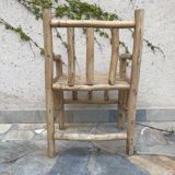 Art-Populaire armchair in raw wood, circa 1950.