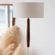 Vintage floor lamp in teak and brass with a cream shade.