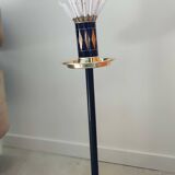 Vintage floor ashtray with a gold and black metal cigarette dispenser.