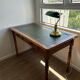 English-style wooden desk with a green leather writing pad.