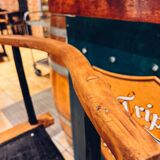 Antique bar stool with wooden seat