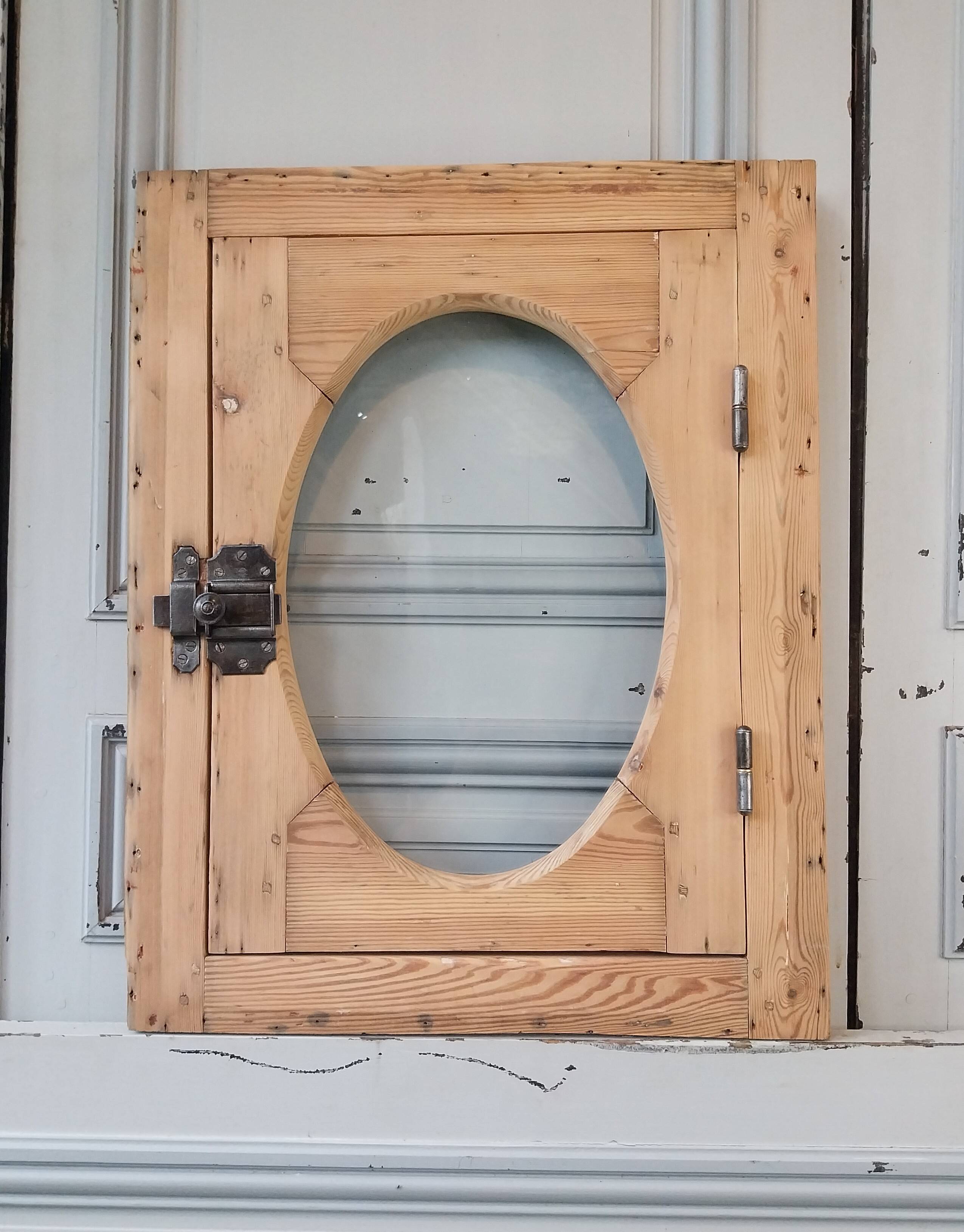 Old bullseye window with oval glass