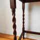 Antique solid oak side table with turned wooden legs.