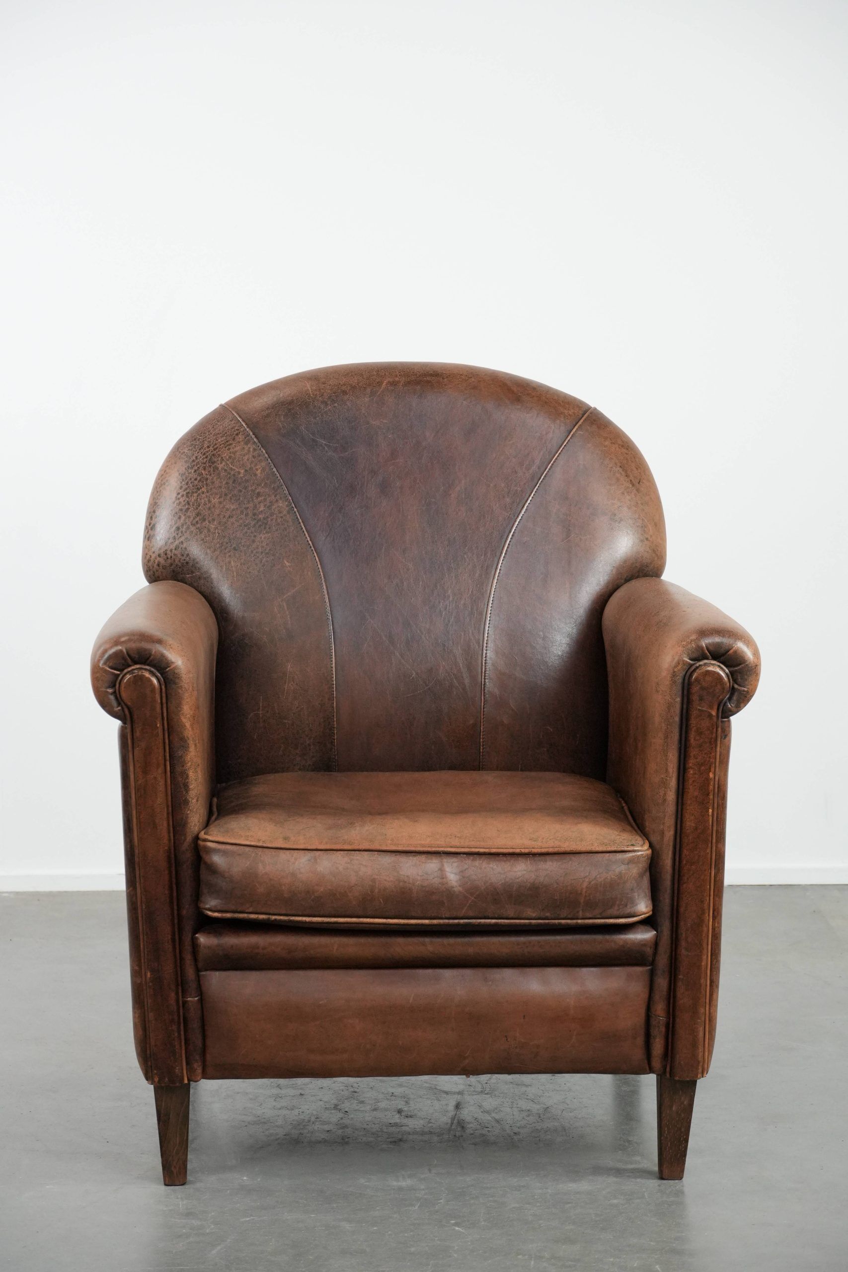 Vintage sheepskin armchair with warm colours and a characterful appearance