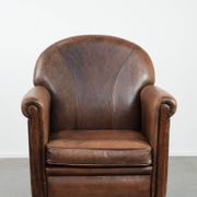 Vintage sheepskin armchair with warm colours and a characterful appearance