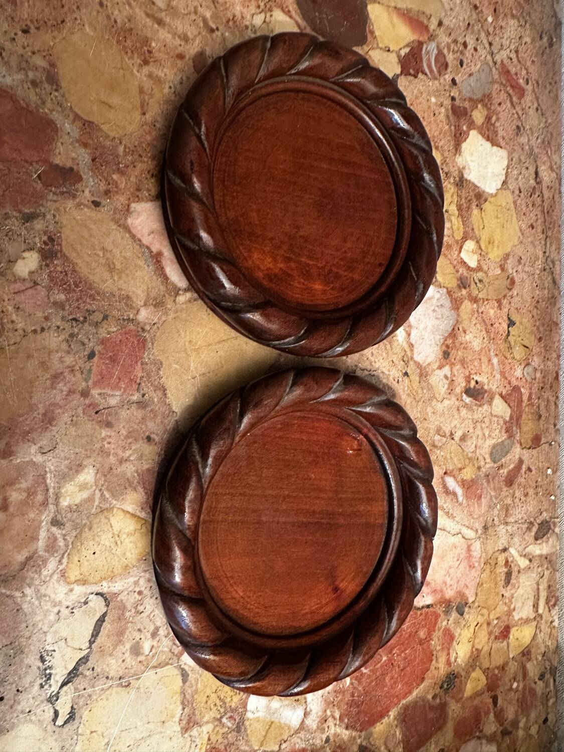 Pair of turned and carved wooden bottle coasters from the 1950s.