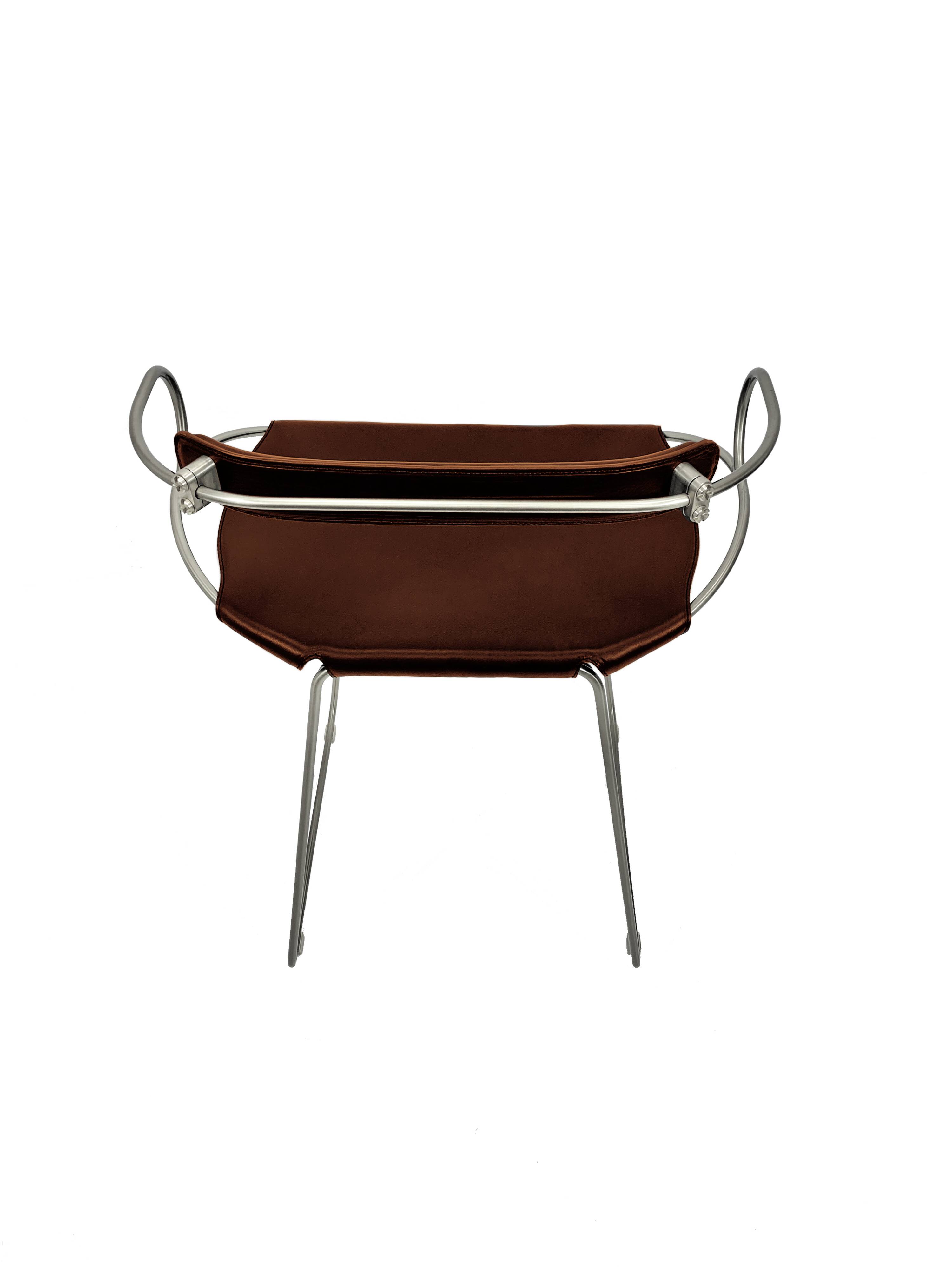 Bar stool with a backrest in aged silver metal and cognac leather, organic design.