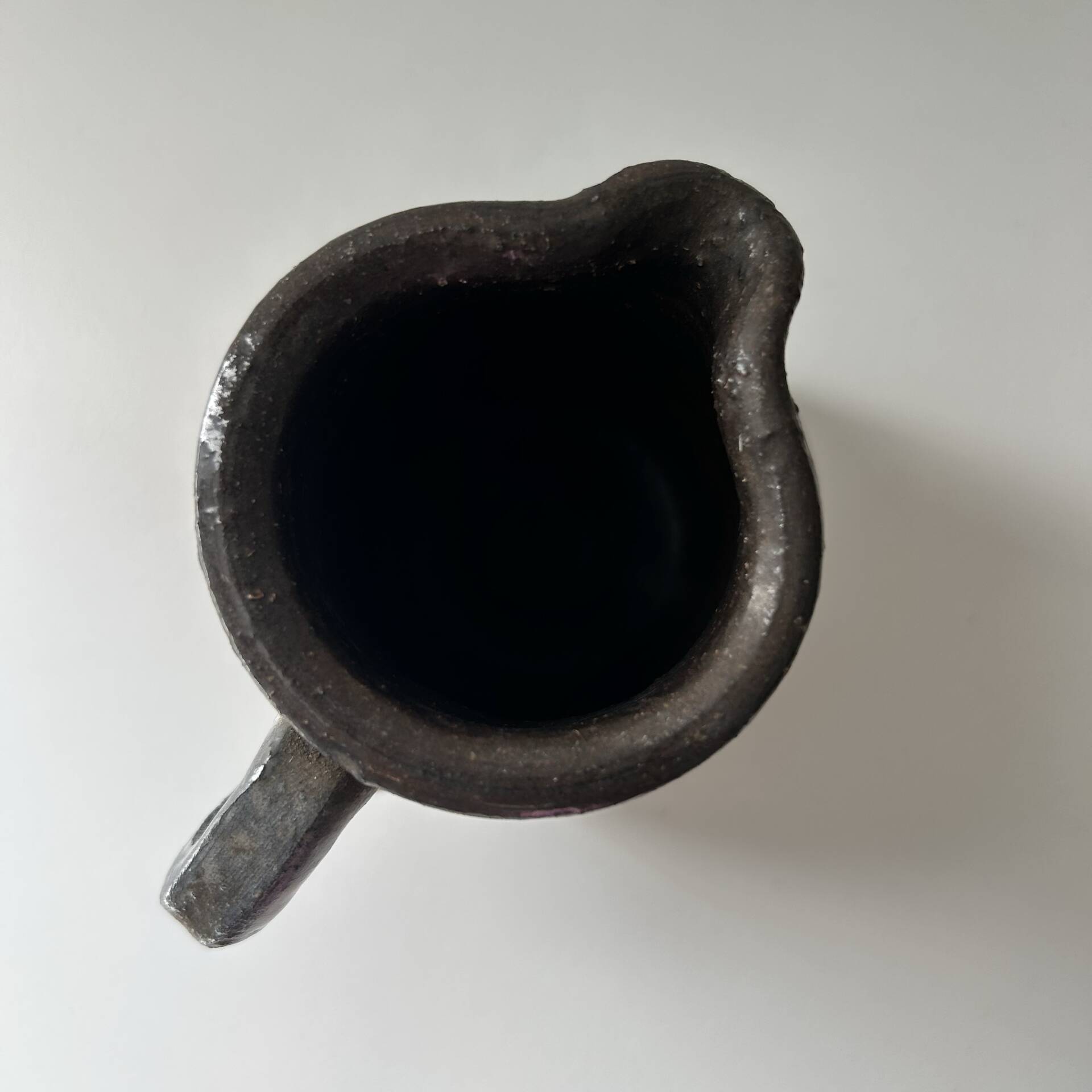 Patinated pitcher signed
