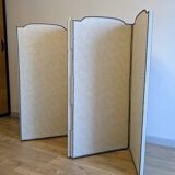 Vintage white faux leather screen with four studded panels, elegant decor.