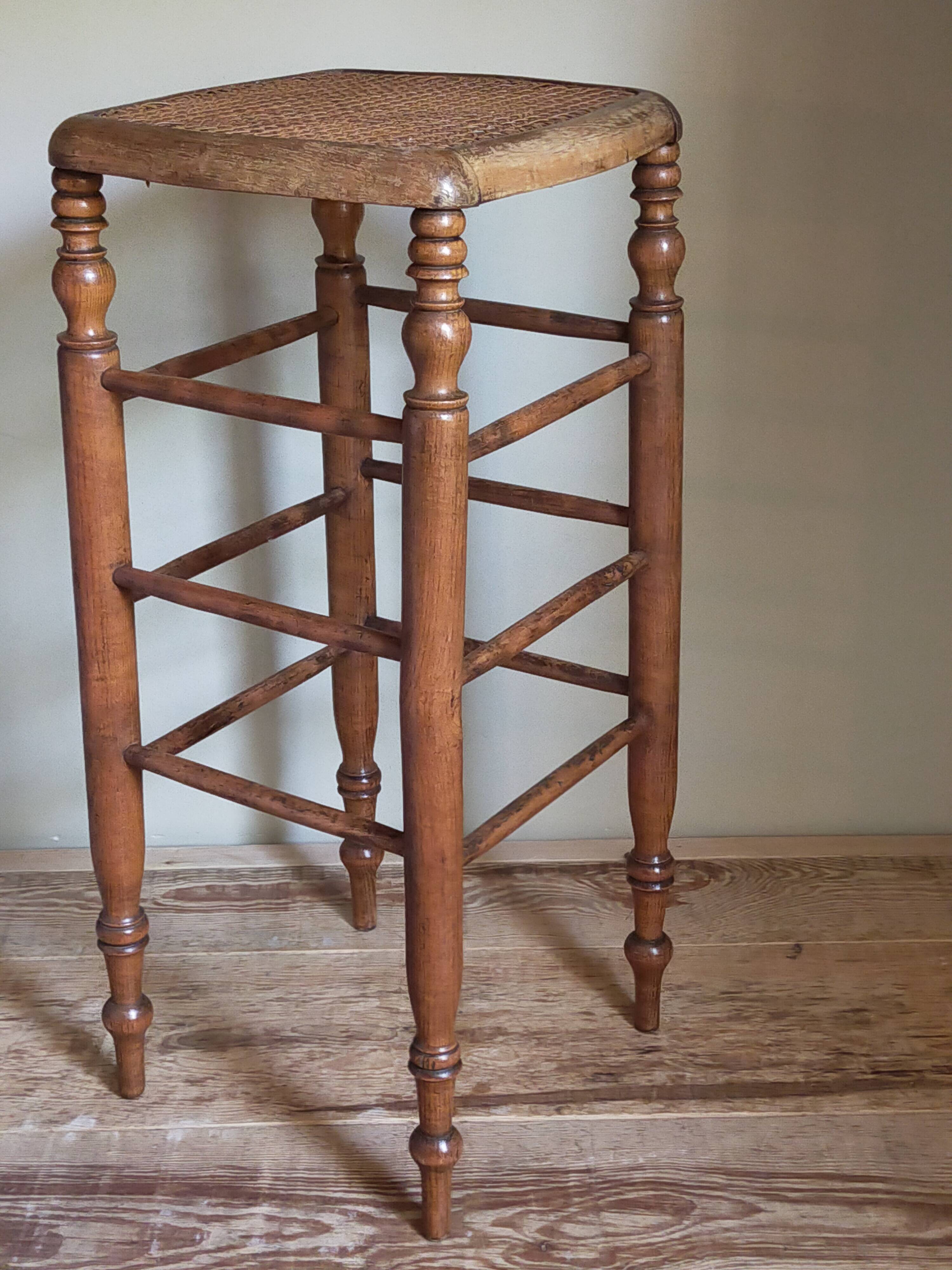 Antique stool with cane and turned wood