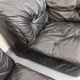 Vintage corner sofa composed of 3 modules in black leather with integrated bed.