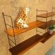 Wall rack with shelves and steel holders, dark wall system