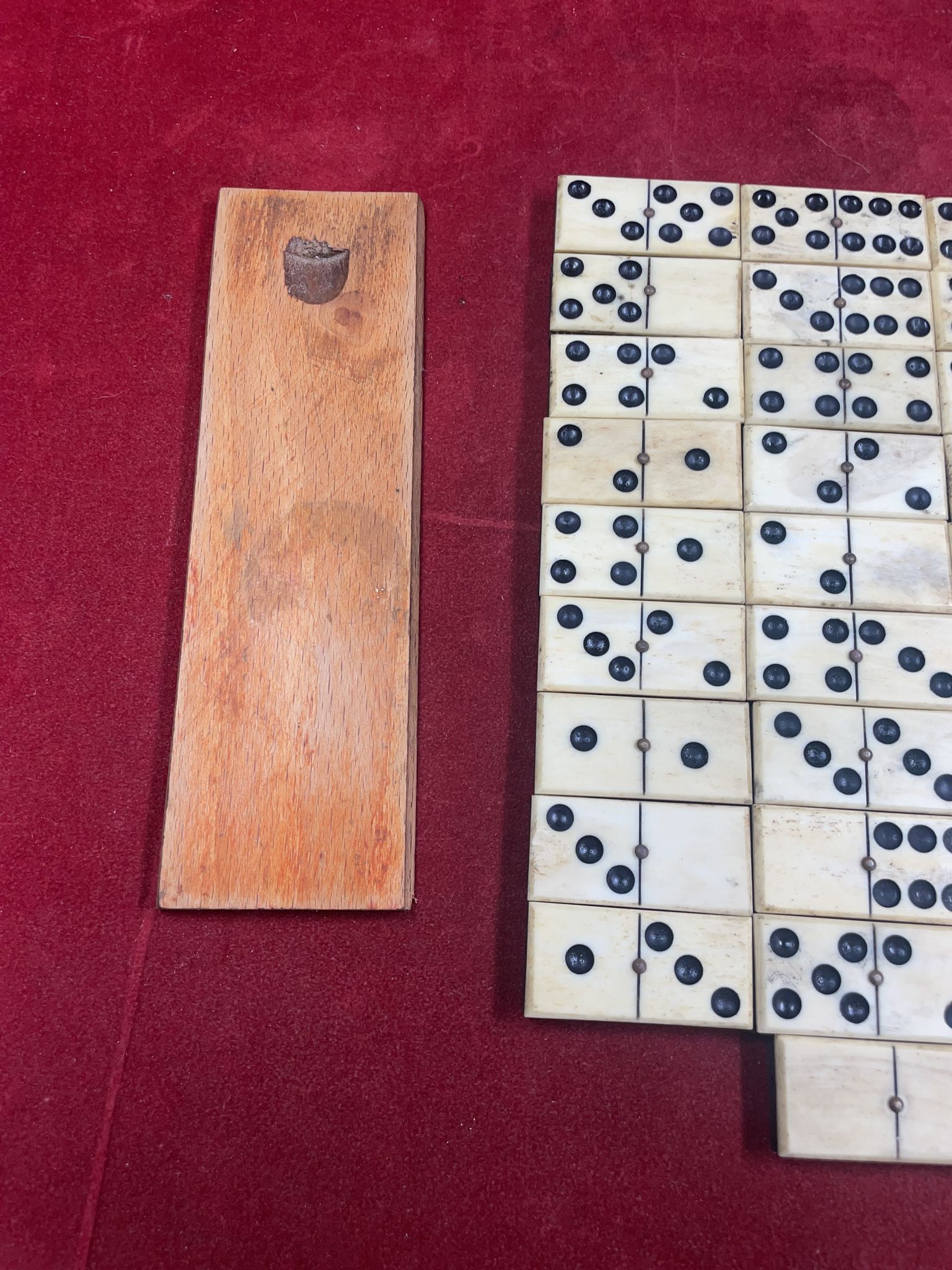 Set of complete dominoes made of bone, nails and blackened wood