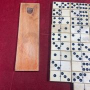Set of complete dominoes made of bone, nails and blackened wood