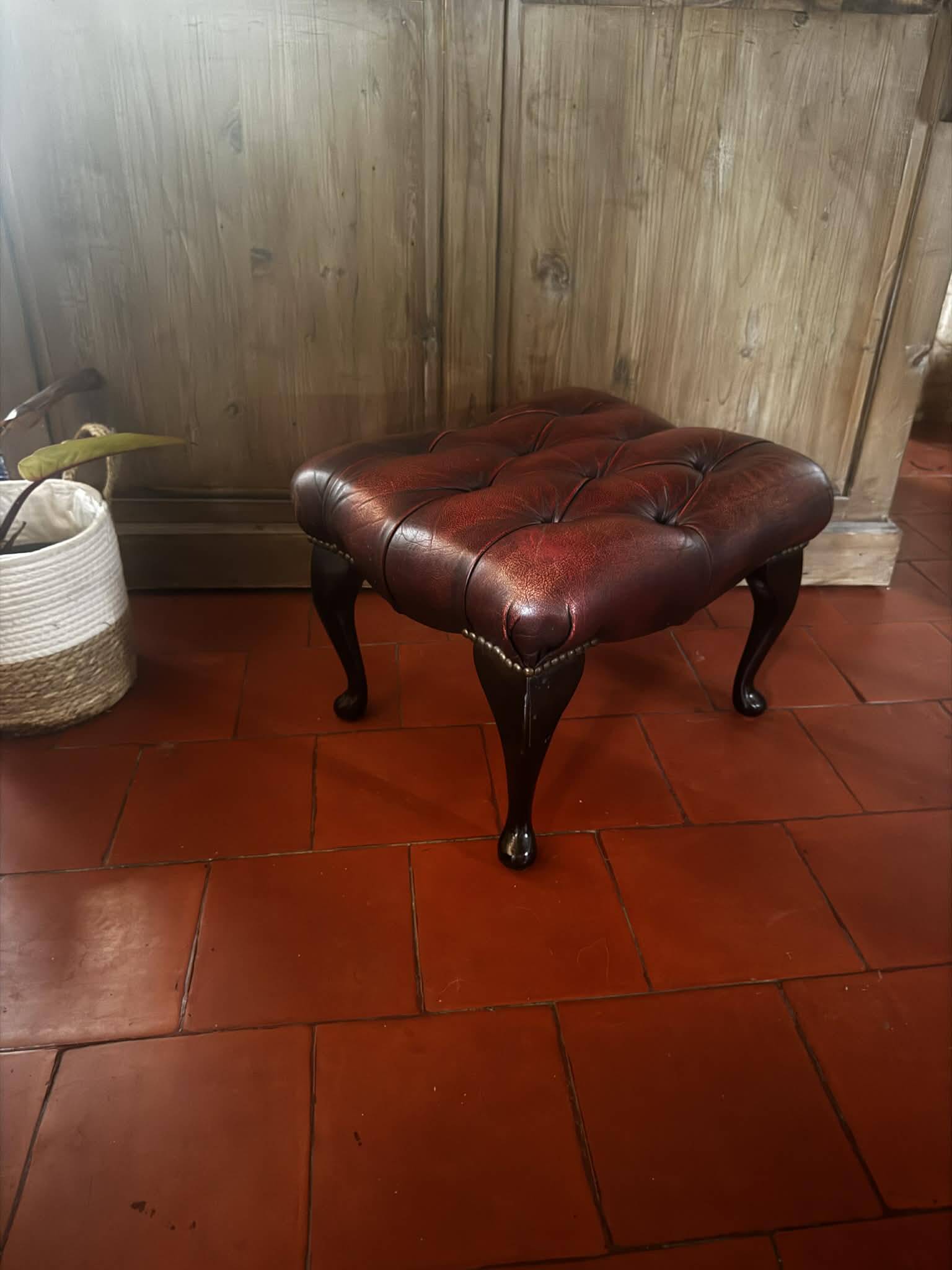 Red leather footrest in Chesterfield style, vintage 1970s.