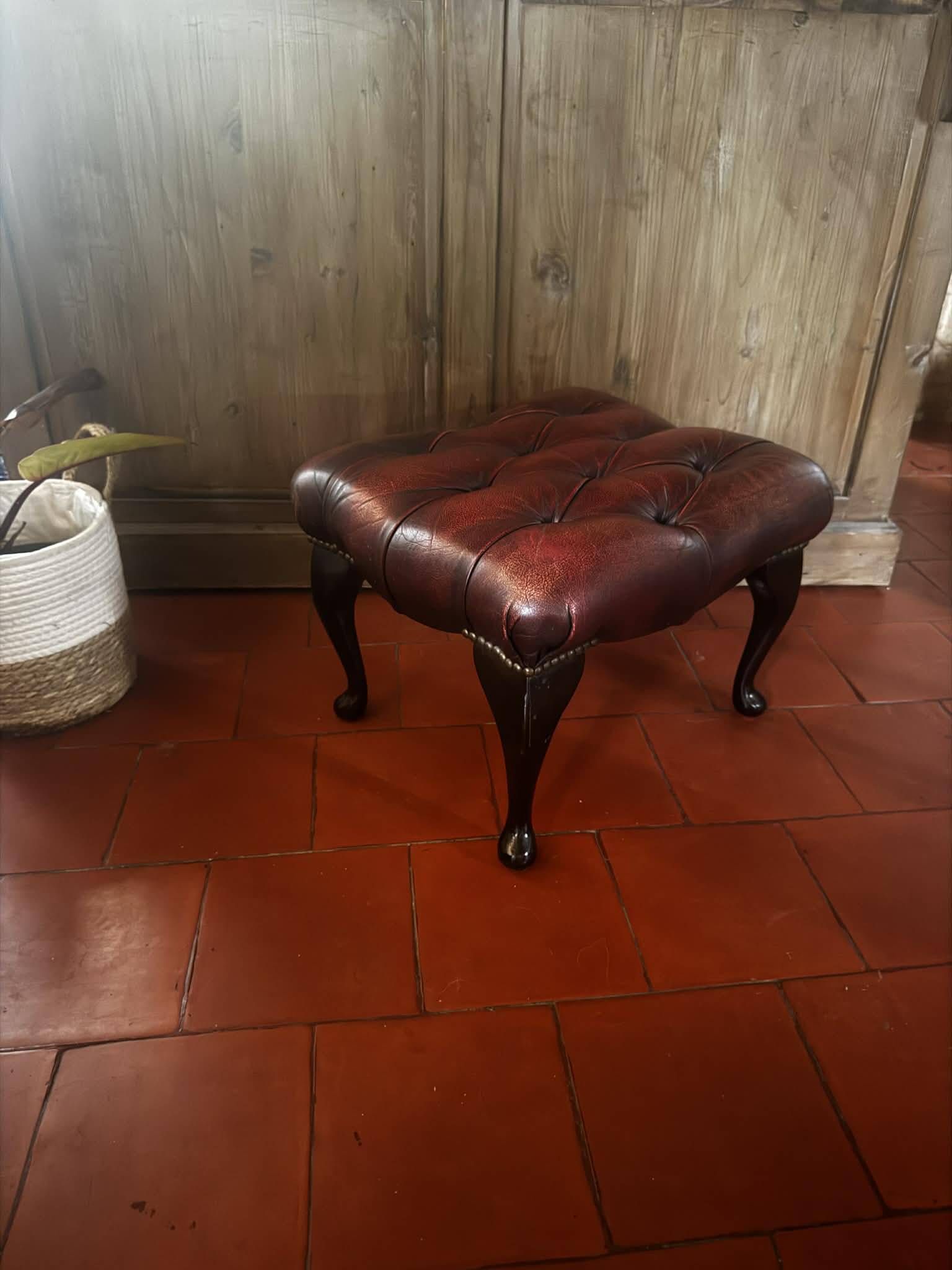 Red leather footrest in Chesterfield style, vintage 1970s.