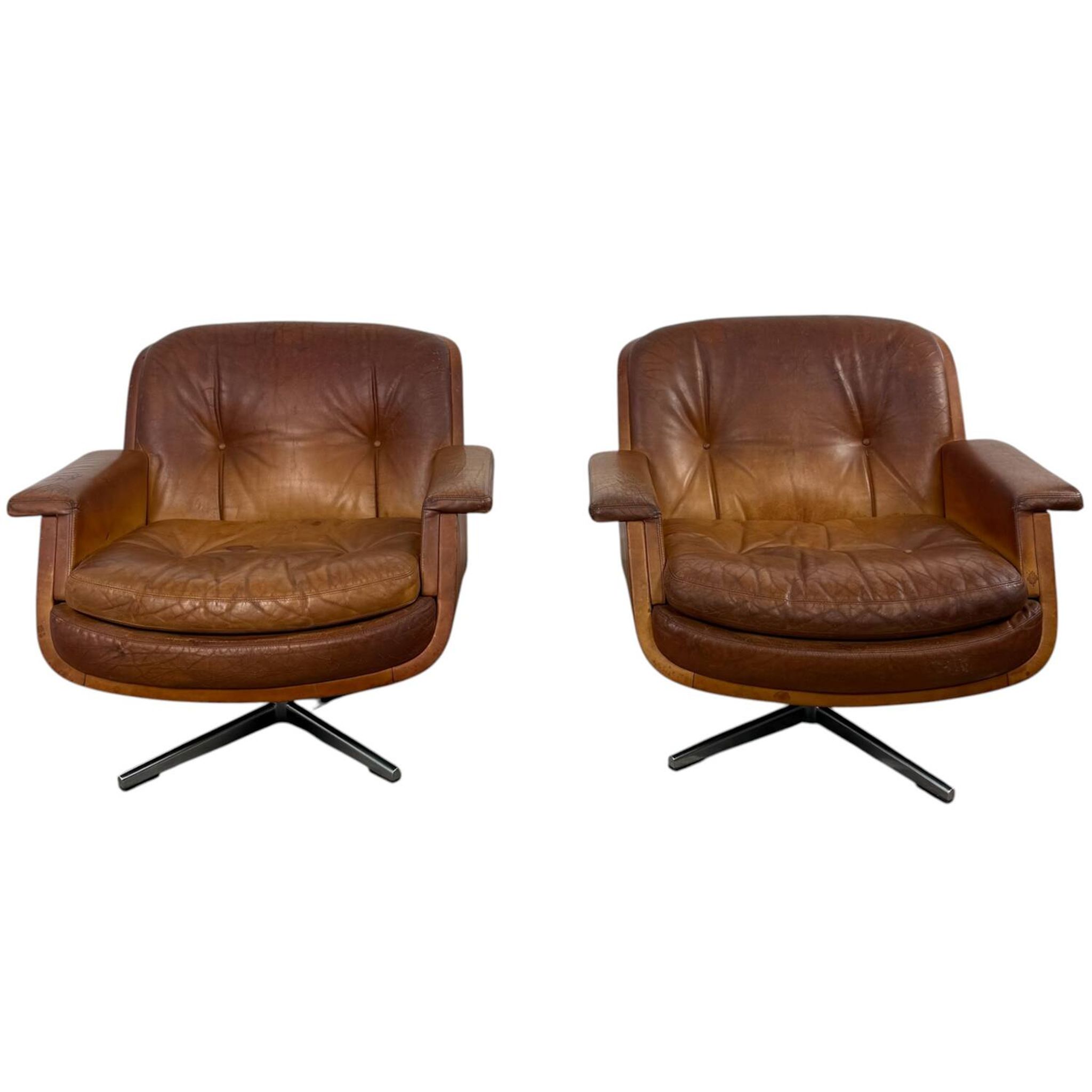 Pair of vintage cognac leather swivel lounge chairs by Eugen Schmidt