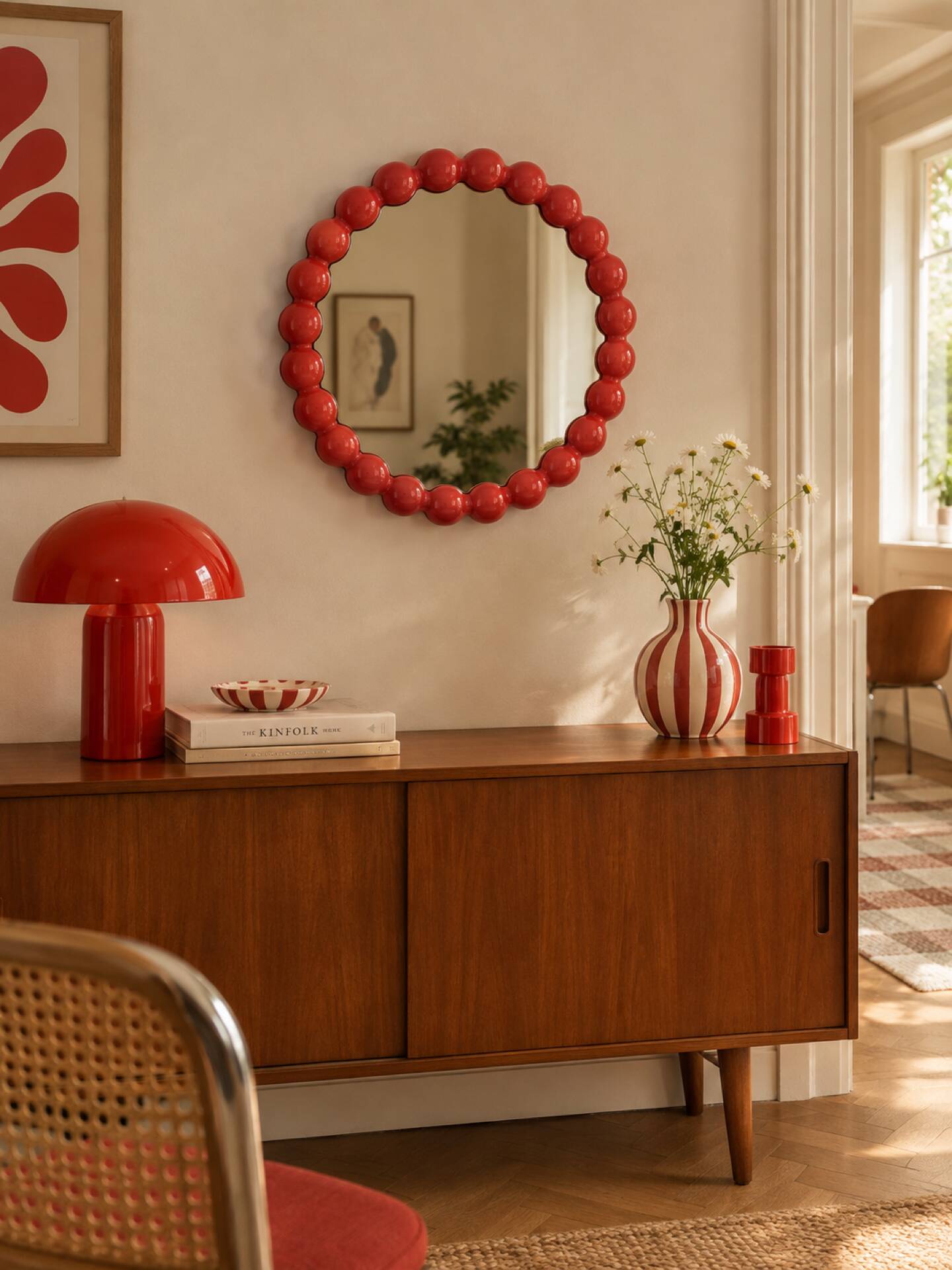Round wall mirror with red beads in vintage retro design style.