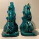 Pair of art deco bookends in enamelled ceramics, doe and hunting dogs