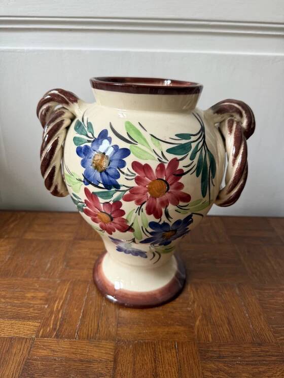 Ceramic vase with hand-painted floral decoration.