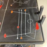 Black metal server and earthenware tiles with geometric patterns