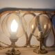 2 bedside lamps with round amber glass globes and gold metal.