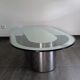 Vintage coffee table with glass and chrome metal.