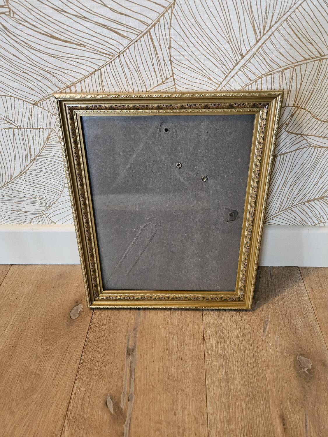 Golden wooden frame with floral patterns