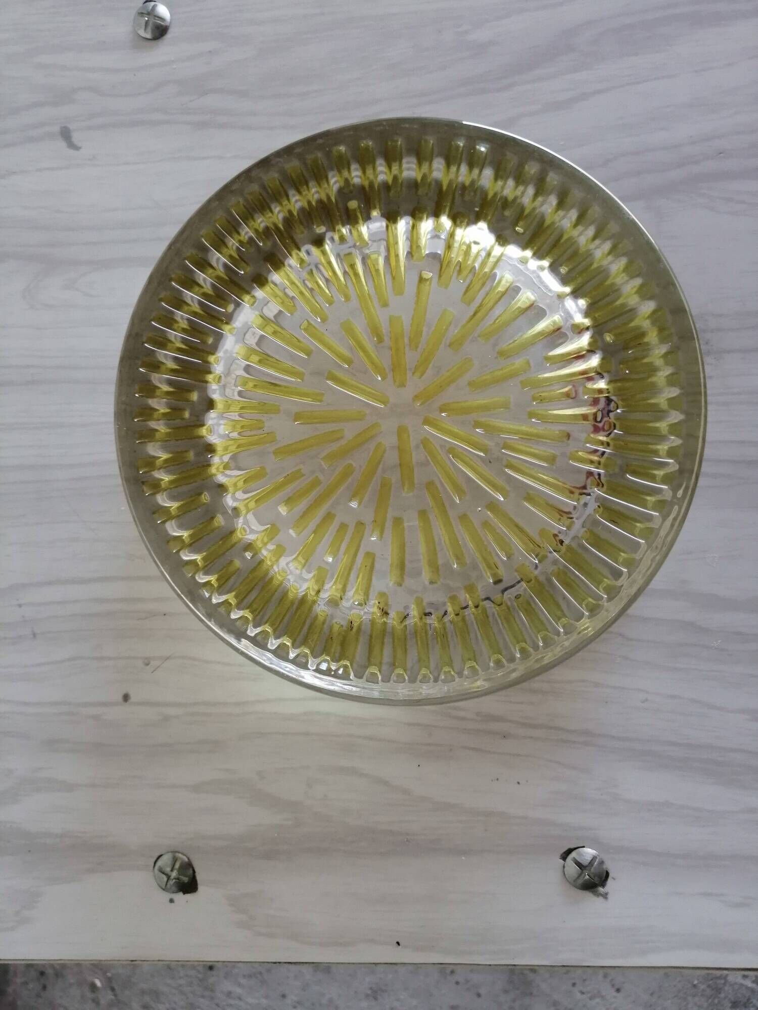 Empty round pockets of iridescent transparent glass of yellow sticks