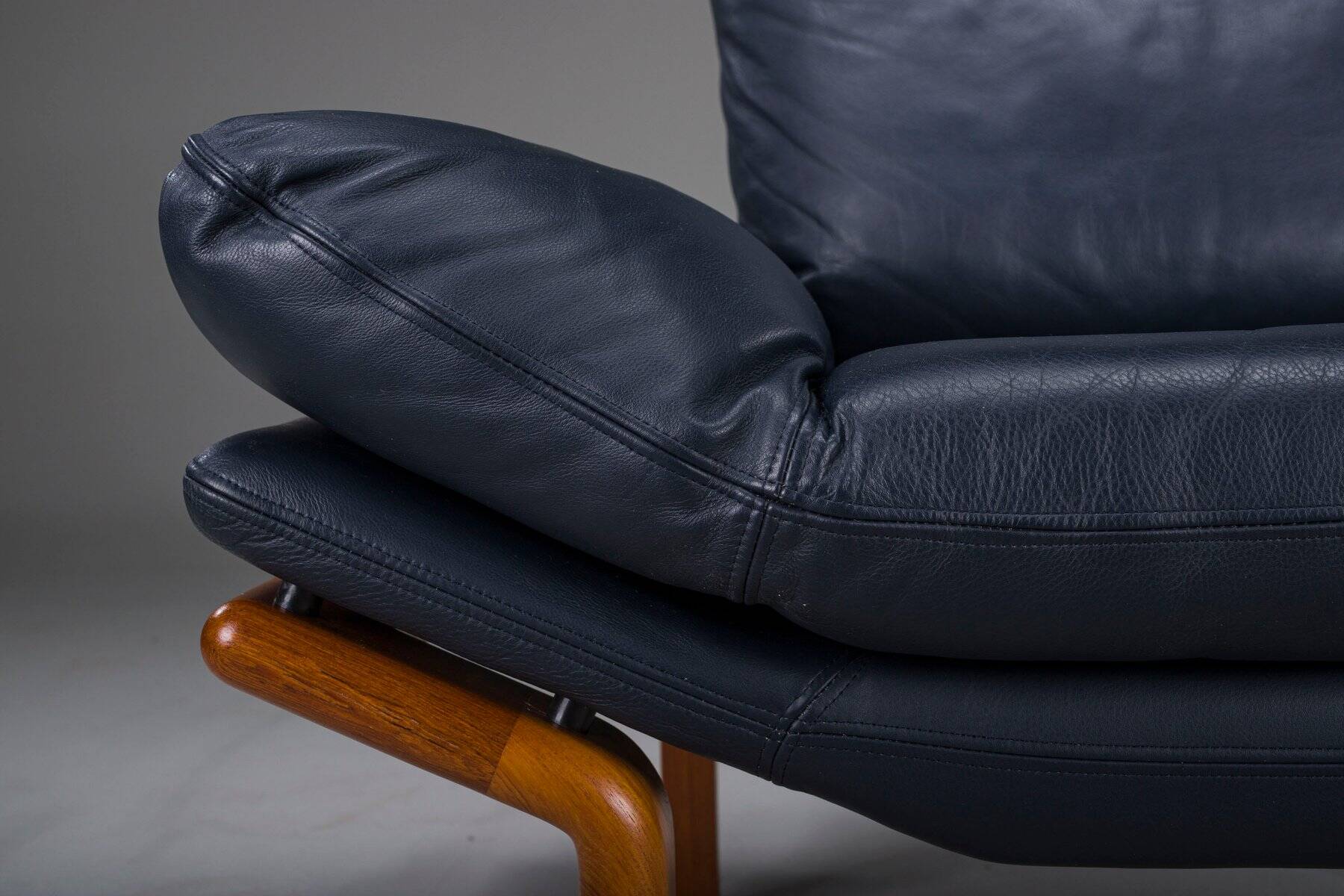Danish teak and navy blue leather lounge chair from Komfort, 1970s
