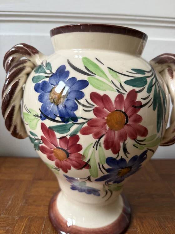 Ceramic vase with hand-painted floral decoration.