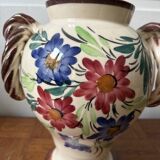 Ceramic vase with hand-painted floral decoration.