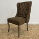 Upholstered armchair in brown imitation leather