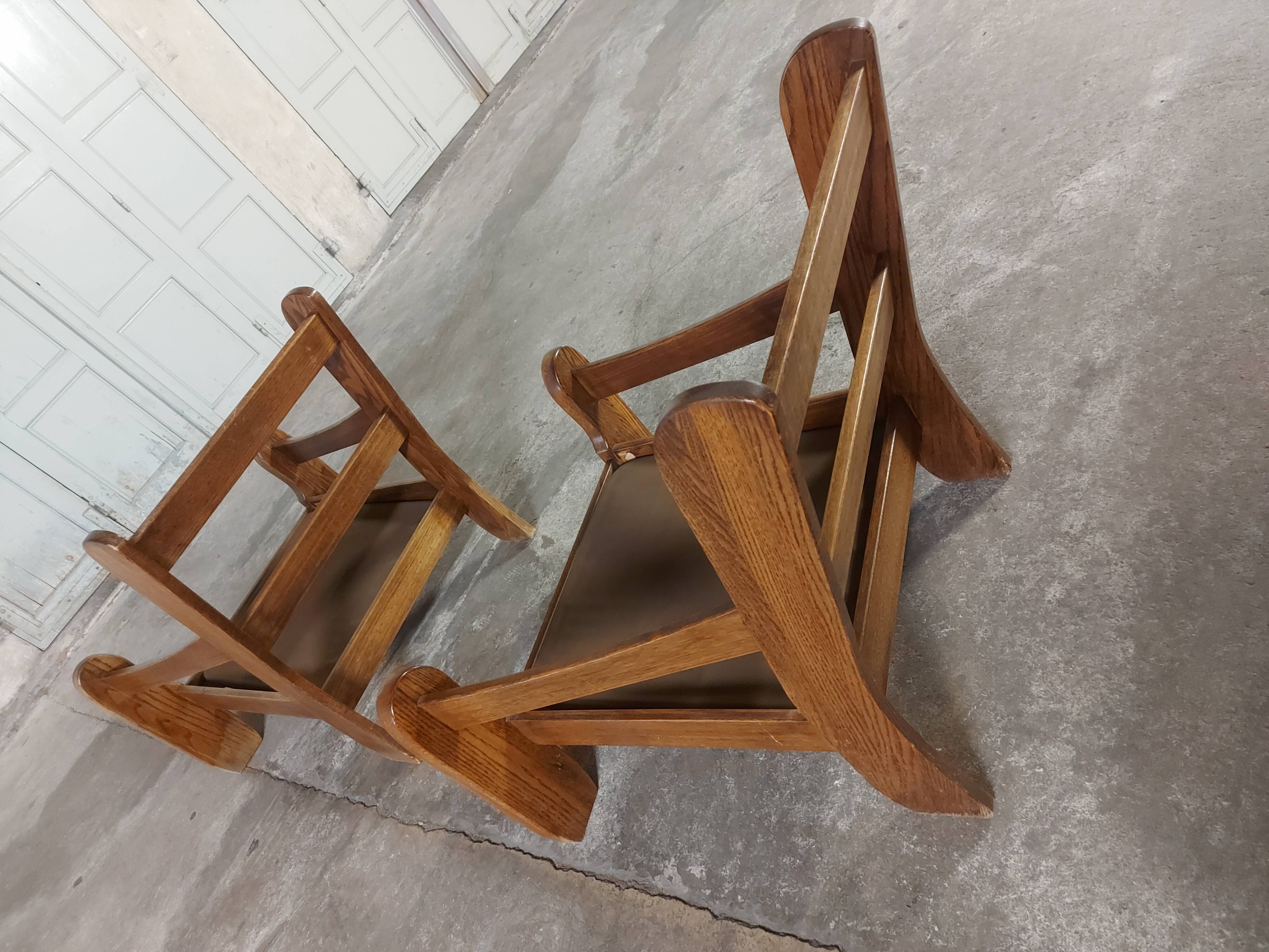 Armchairs in leather and vintage wood 70's