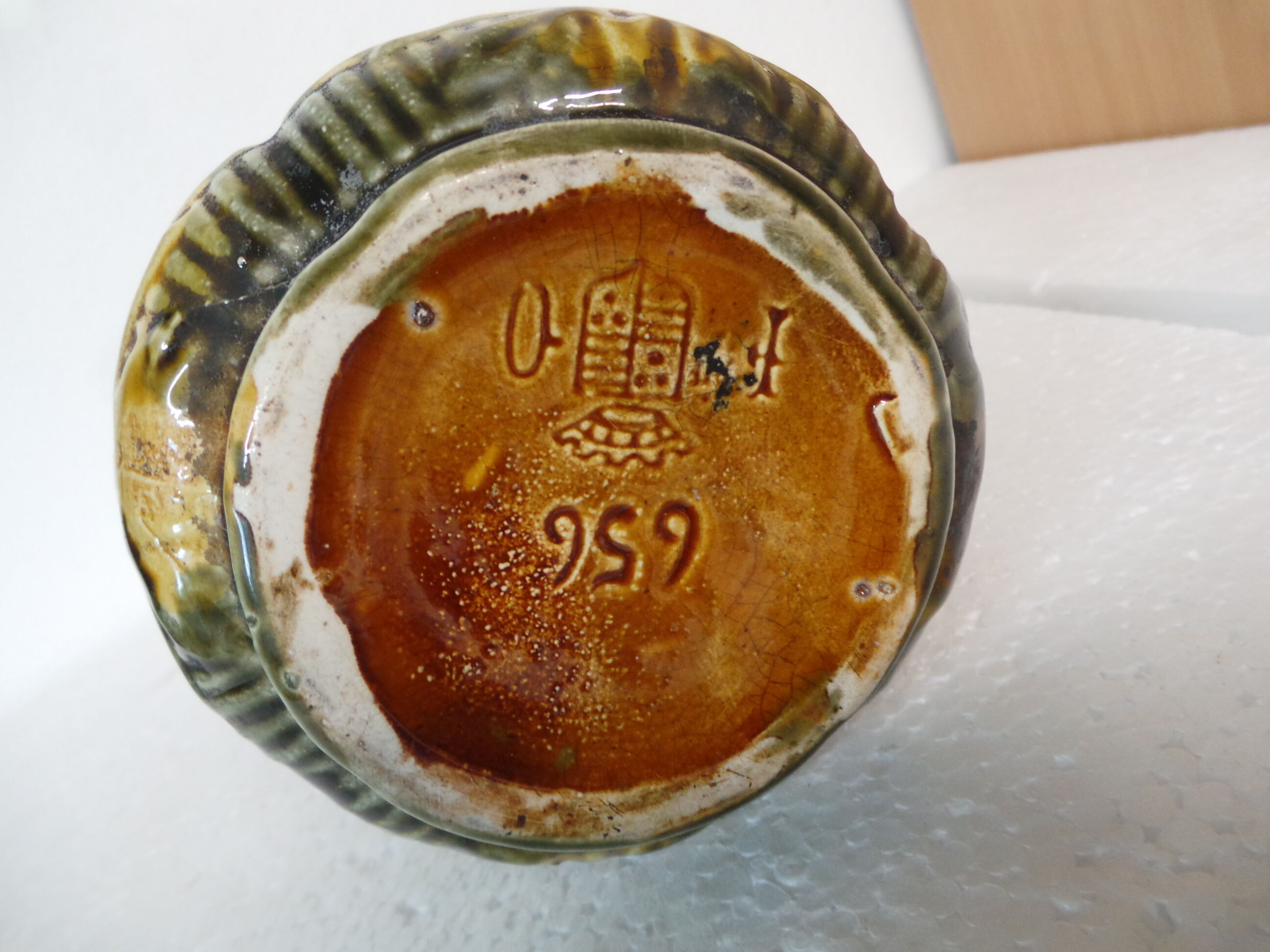 Pitcher dabbling in butterfly and flower decoration