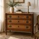 Light walnut commode in Louis XVI style with fluted motifs and three drawers.