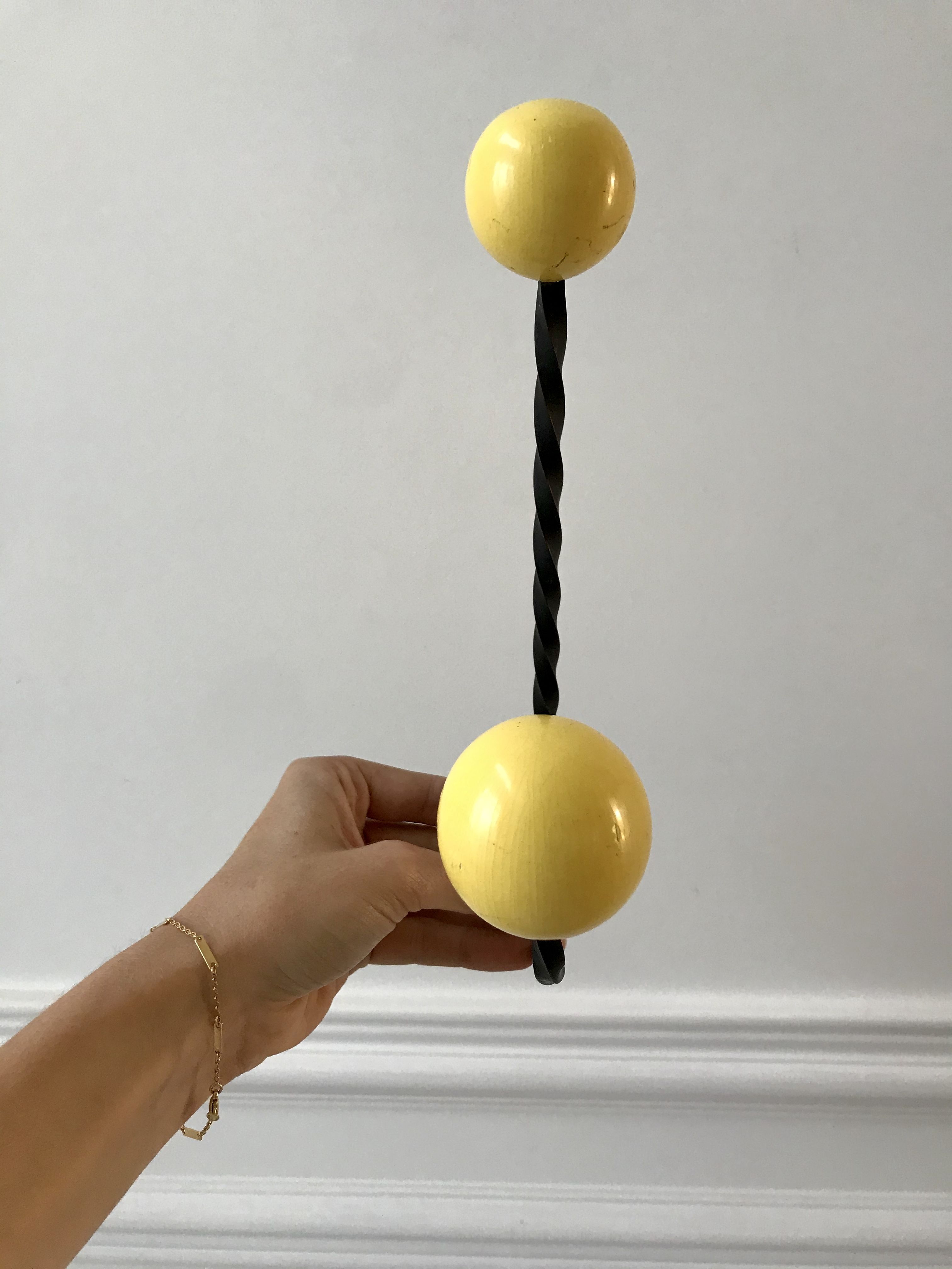 Duo of hooks balls in yellow wood and black iron 60s