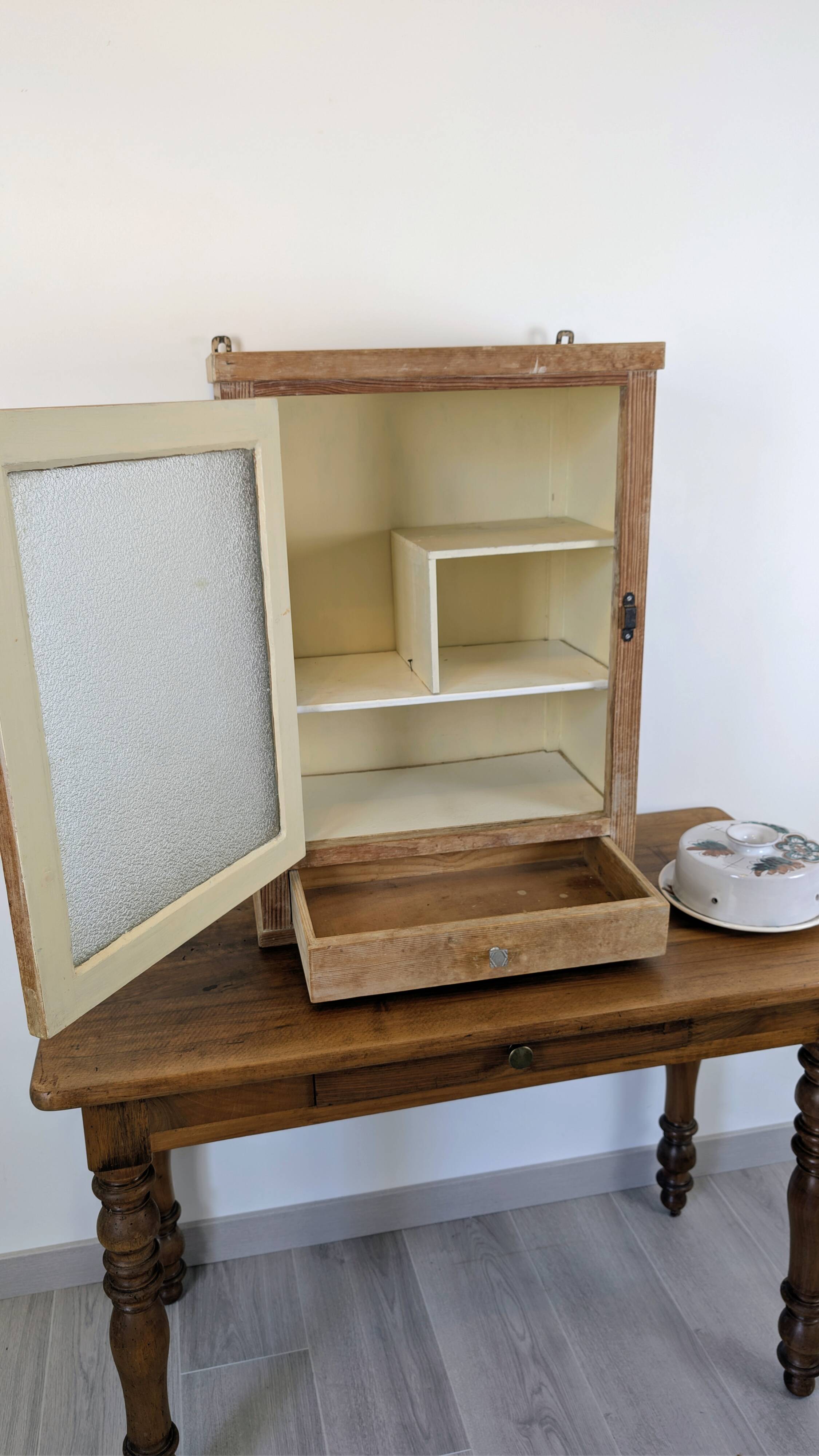 Small glass wall cabinet from the 1960s.