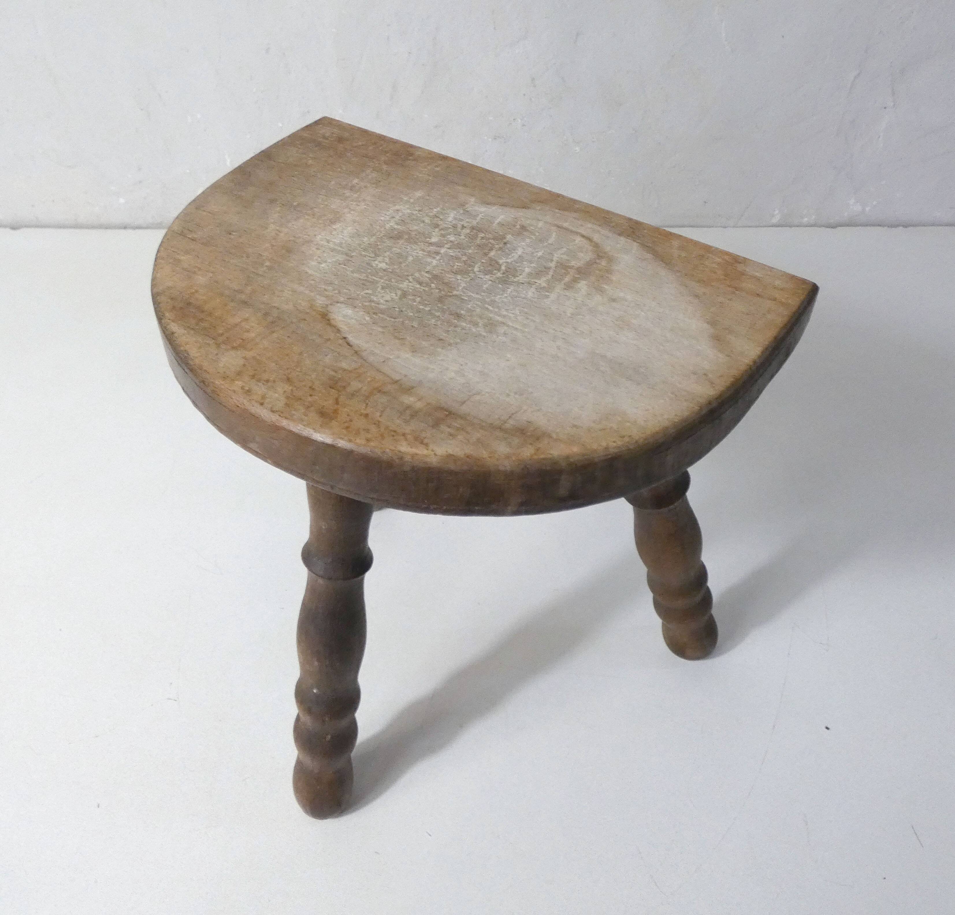 Old milking bench tripod stool in solid wood