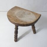 Old milking bench tripod stool in solid wood