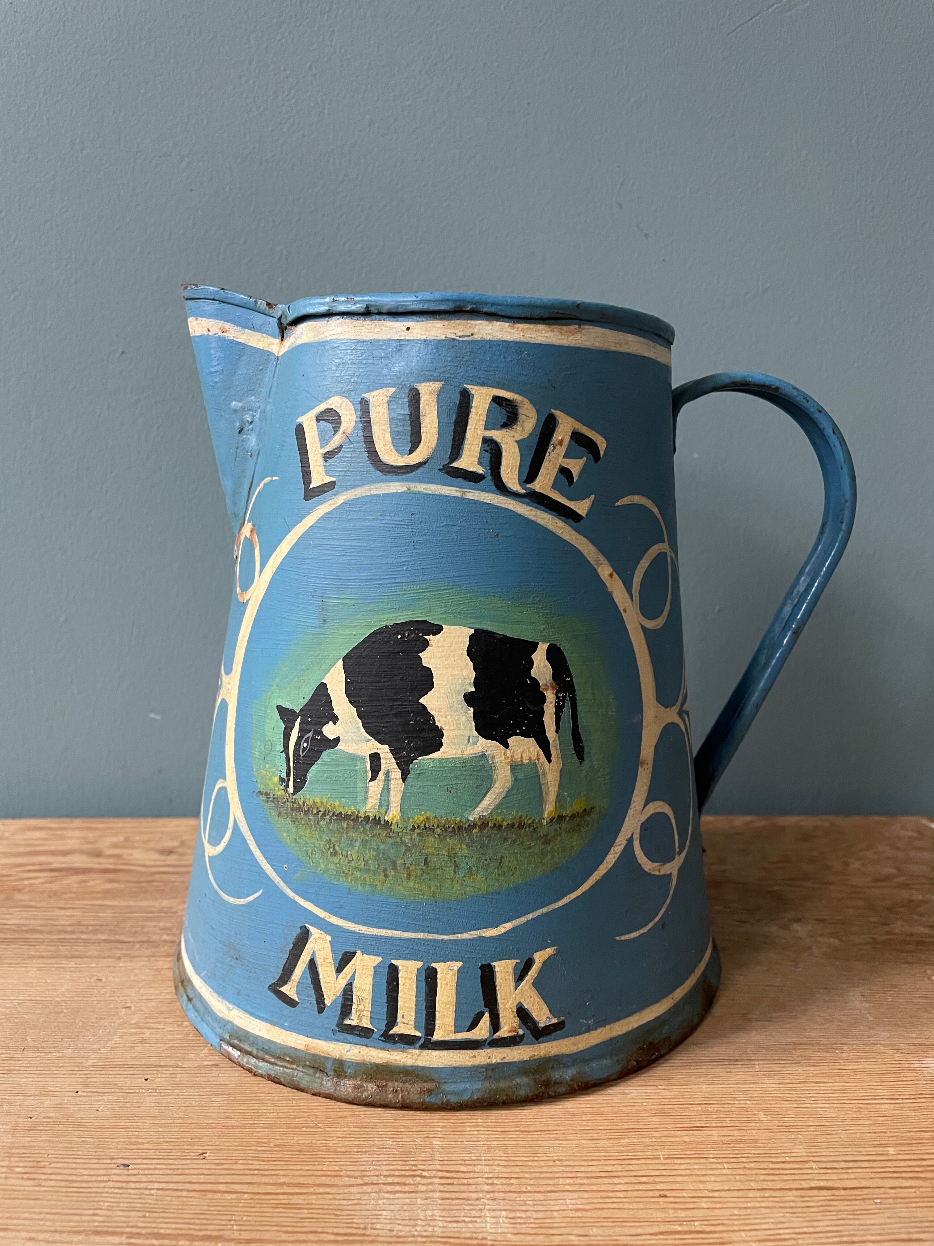 Old painted sheet metal jug or milk jug