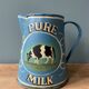 Old painted sheet metal jug or milk jug