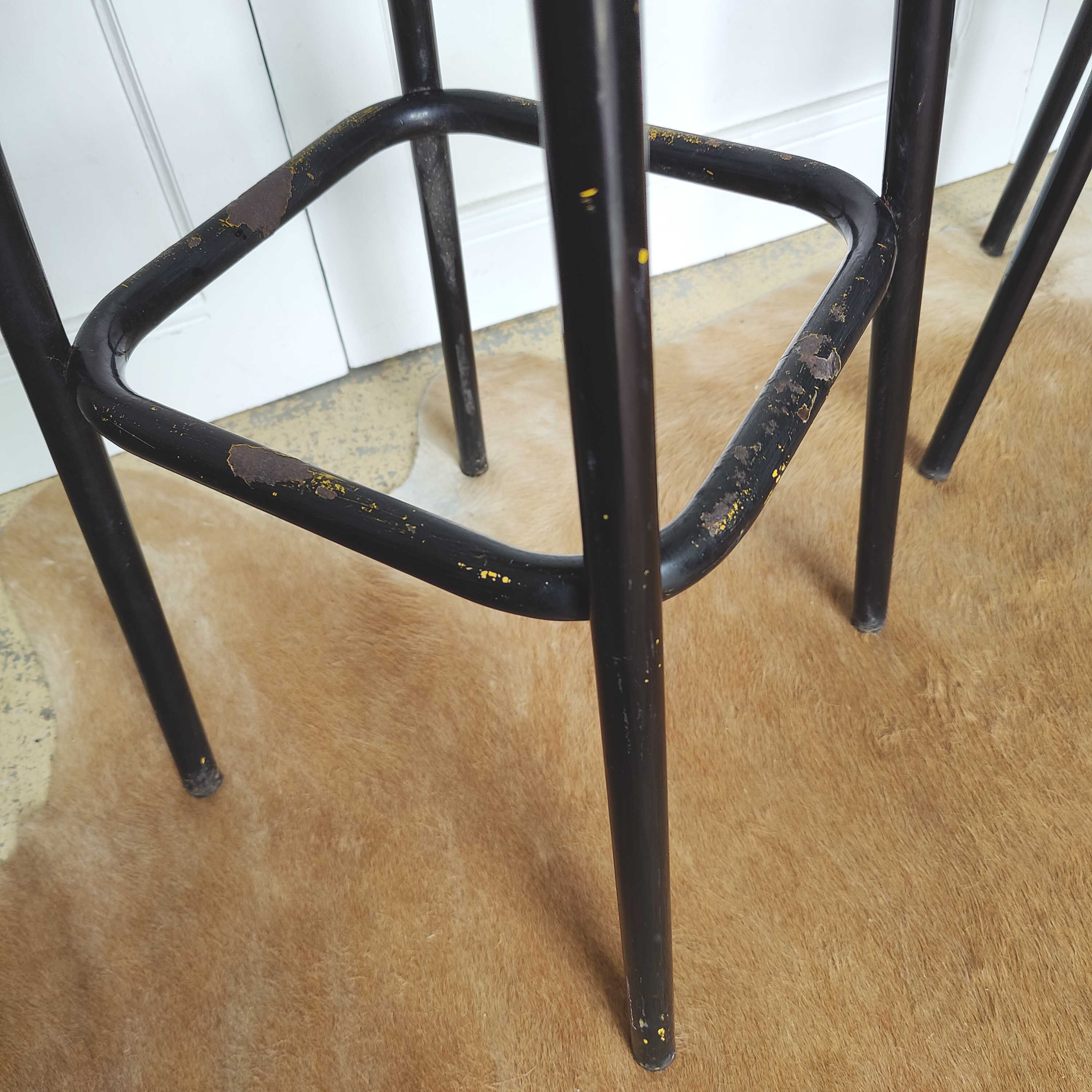 Pair of black metal bar stools and yellow imitation leather seat