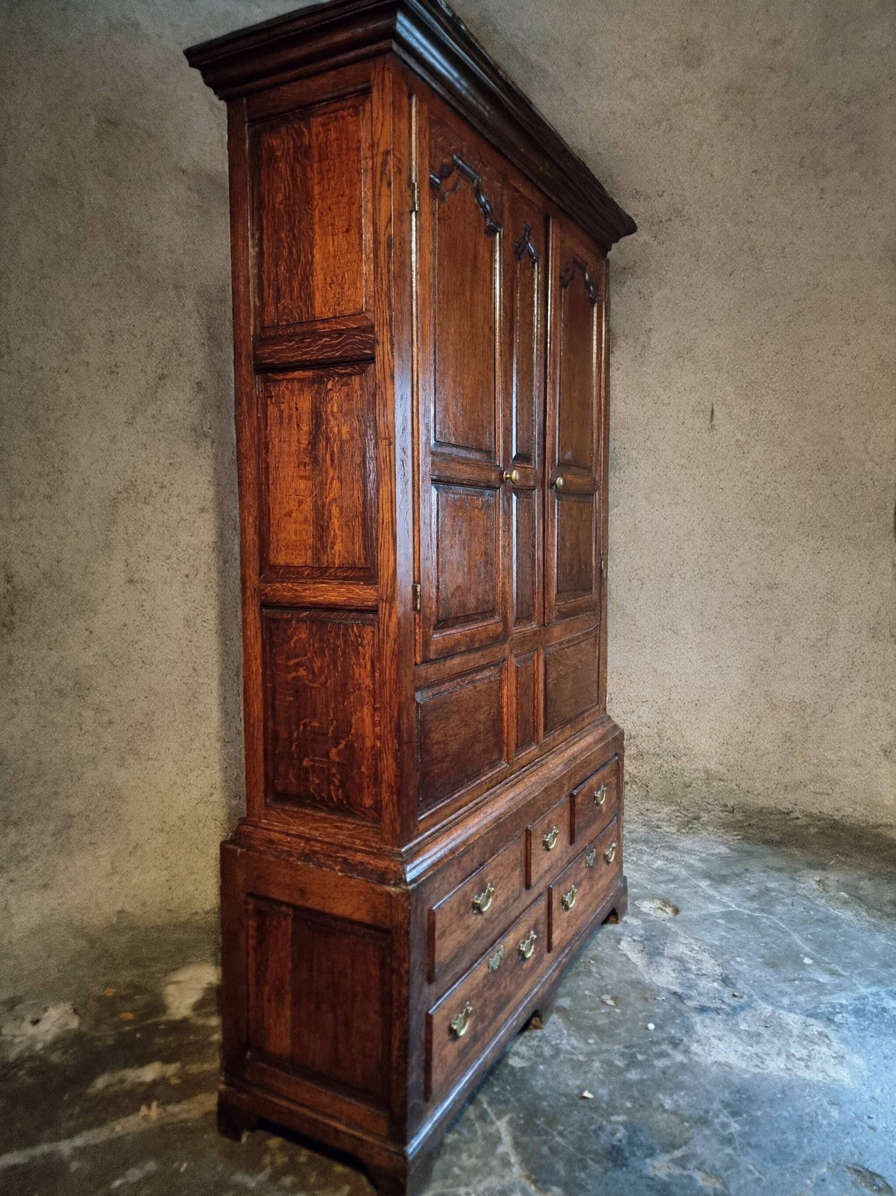 Antique English oak wardrobe with drawers, England, circa 1800–1820.