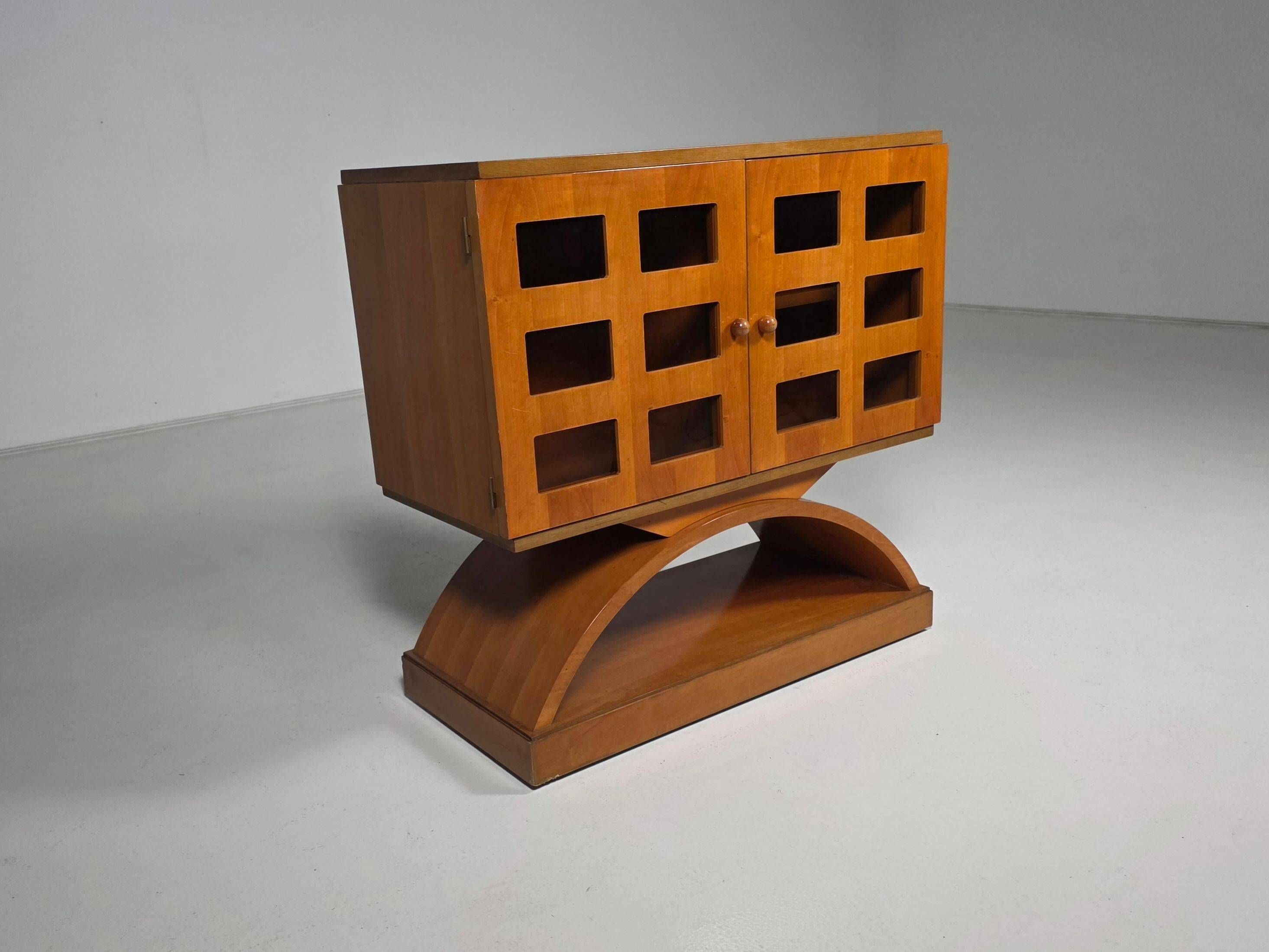 Mid-century modern mobile bar cabinet with sculptural base, 1950s.