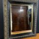 19th-century mirror Napoleon III in blackened wood on a gold background.